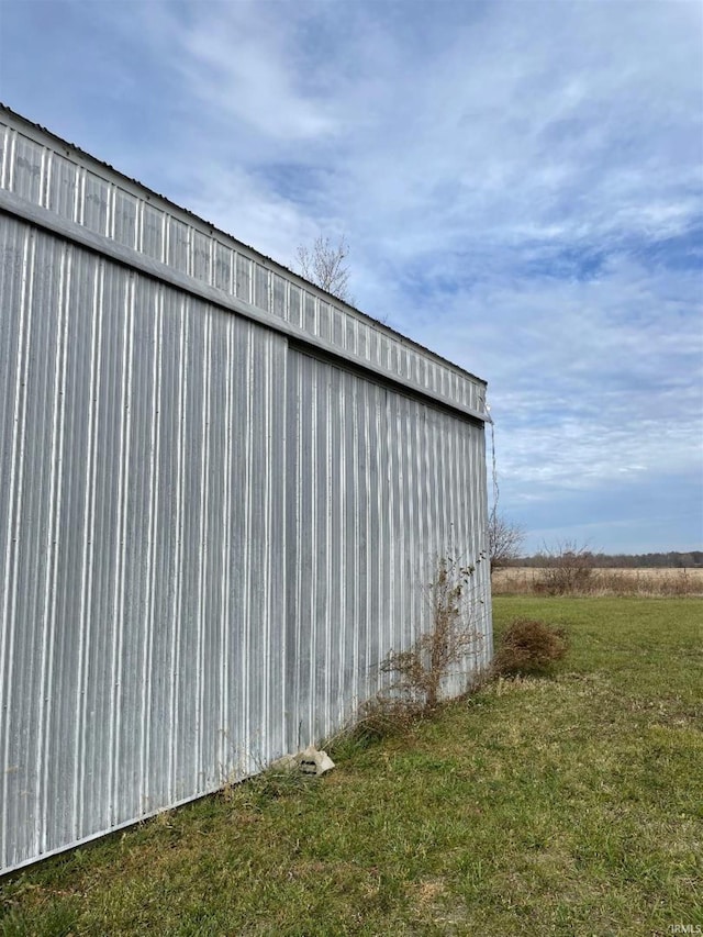 view of outbuilding with a yard