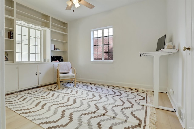 sitting room with ceiling fan and light hardwood / wood-style flooring