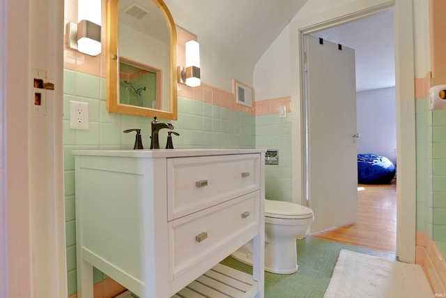 bathroom featuring vanity, wood-type flooring, tile walls, and toilet