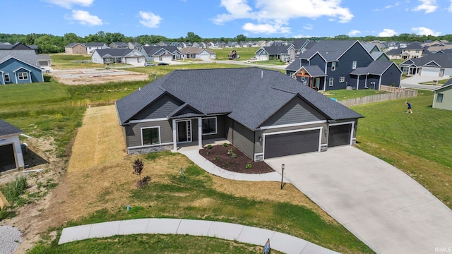 view of front of house featuring a garage and a front lawn