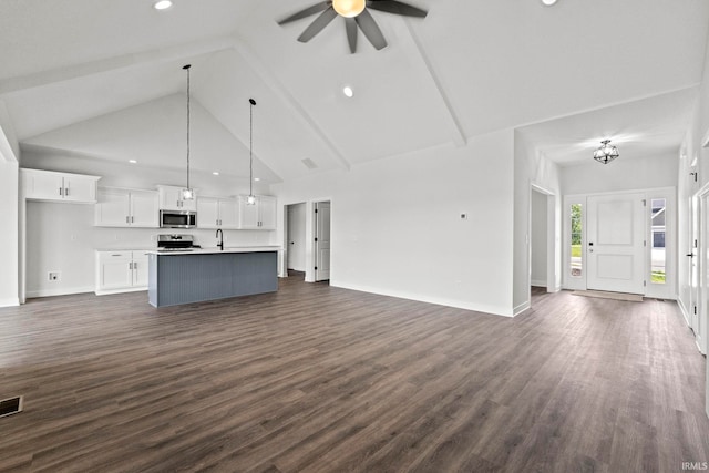 unfurnished living room with dark wood-type flooring, high vaulted ceiling, sink, and ceiling fan