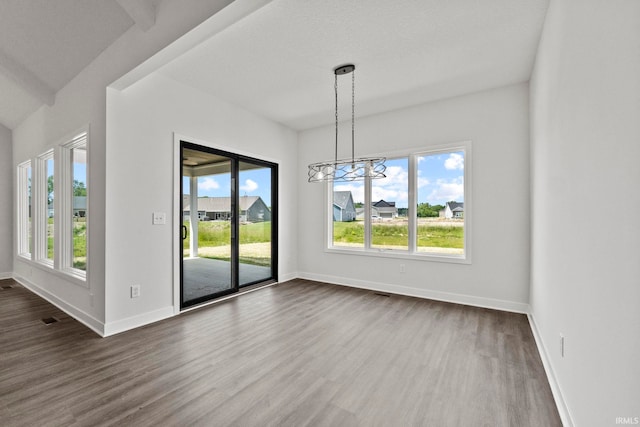 unfurnished dining area with a wealth of natural light and dark hardwood / wood-style flooring