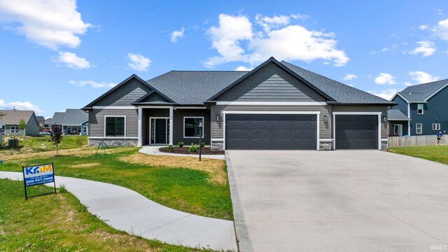 craftsman-style home featuring a garage and a front yard