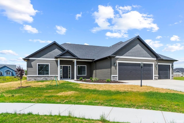 view of front of house with a garage and a front lawn