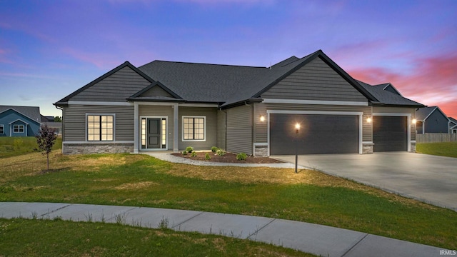 view of front of home featuring a garage and a yard