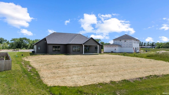 rear view of property featuring a yard