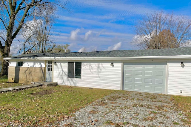 view of front facade with a garage and a front lawn