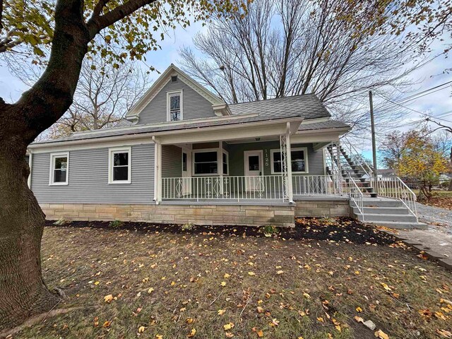 view of front of house featuring a porch and a shingled roof