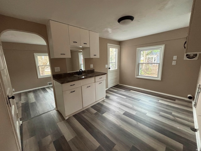 kitchen with white cabinets, sink, wood-type flooring, and plenty of natural light