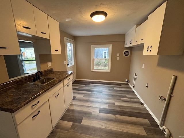 kitchen featuring white cabinets, a wealth of natural light, sink, and dark hardwood / wood-style floors