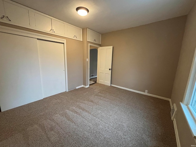 unfurnished bedroom featuring a closet and carpet flooring