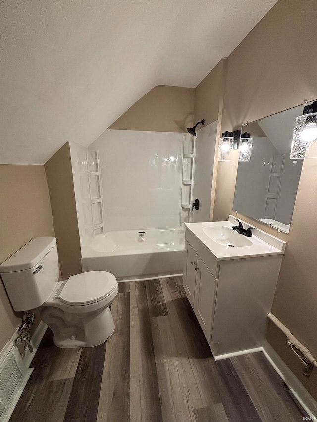 full bathroom with toilet, vaulted ceiling, hardwood / wood-style flooring, and shower / washtub combination