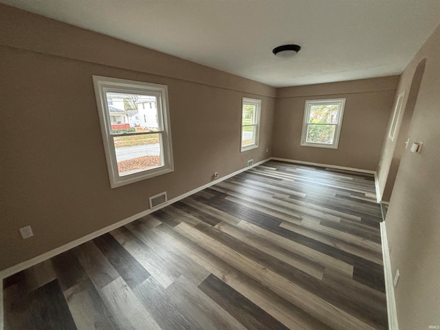 unfurnished room featuring dark hardwood / wood-style flooring