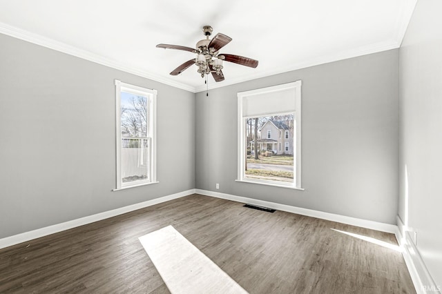 unfurnished room featuring dark hardwood / wood-style floors, ceiling fan, and crown molding