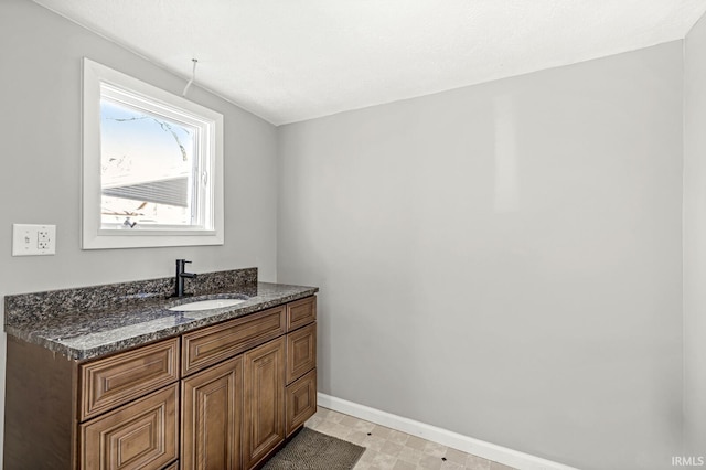 bathroom with a textured ceiling and vanity