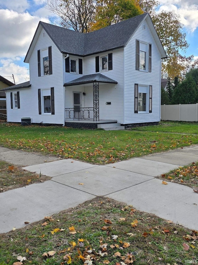 view of front of property with covered porch and a front lawn