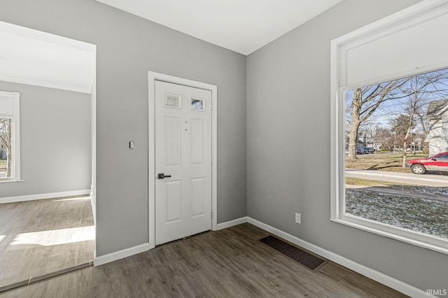 entryway with dark hardwood / wood-style flooring