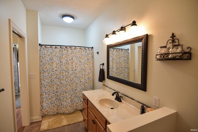 bathroom with vanity, a textured ceiling, tile patterned flooring, and curtained shower