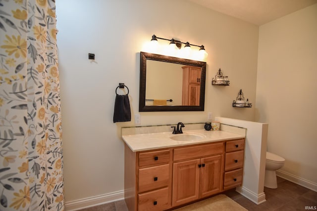 bathroom featuring toilet, vanity, tile patterned flooring, and walk in shower