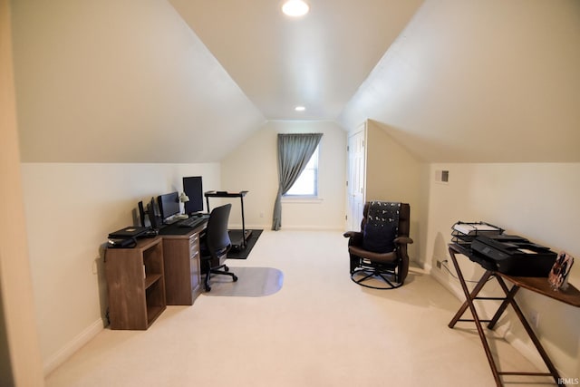 carpeted home office featuring vaulted ceiling