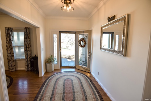 entrance foyer with ornamental molding and dark wood-type flooring