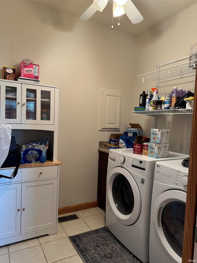 laundry area featuring separate washer and dryer, cabinets, ceiling fan, and light tile patterned floors