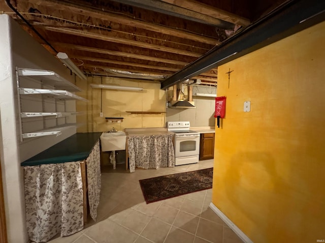 basement with sink and light tile patterned floors