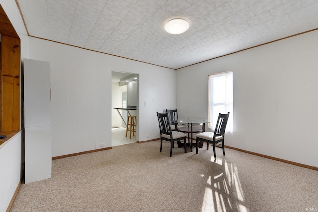 dining room featuring light carpet