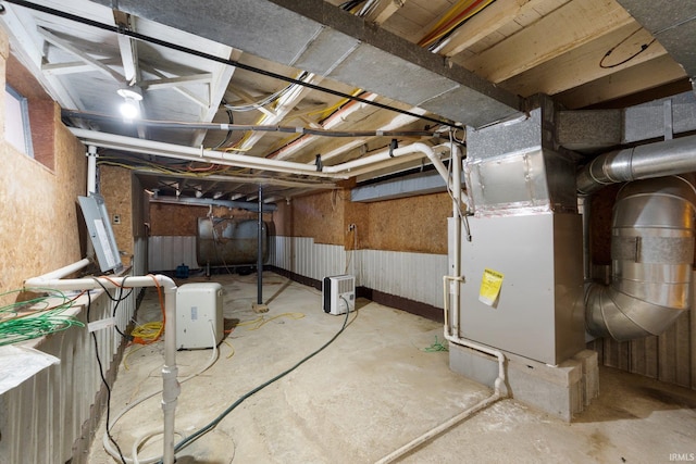 basement with electric panel and heating unit