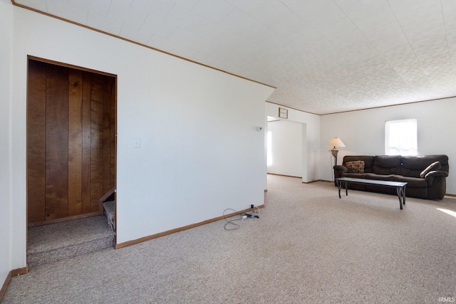 living area with light colored carpet and ornamental molding