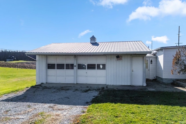 garage featuring a lawn