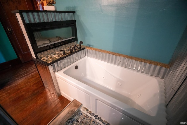 bathroom featuring hardwood / wood-style flooring and a bathtub