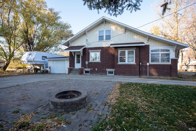 view of front of house with a fire pit and a garage