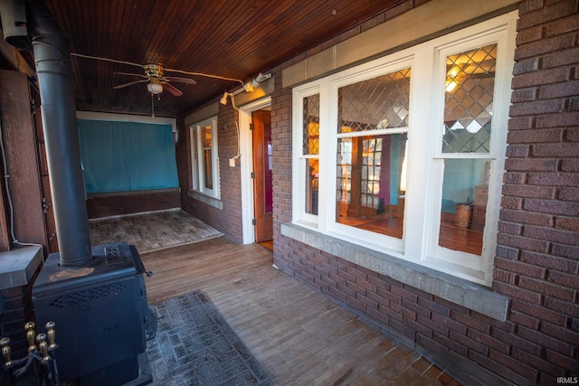 wooden terrace with ceiling fan and covered porch