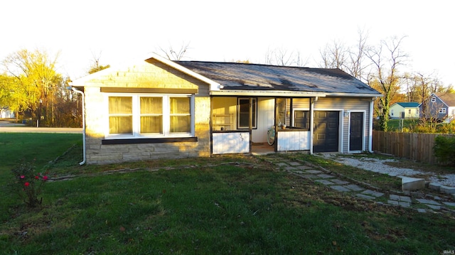 rear view of house featuring a yard