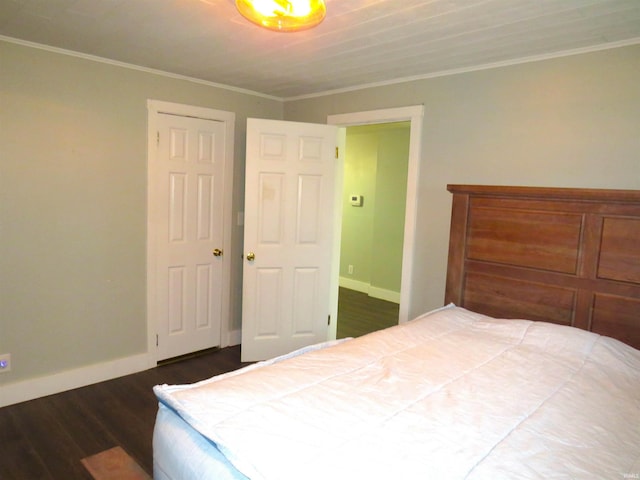 bedroom with dark hardwood / wood-style floors and ornamental molding