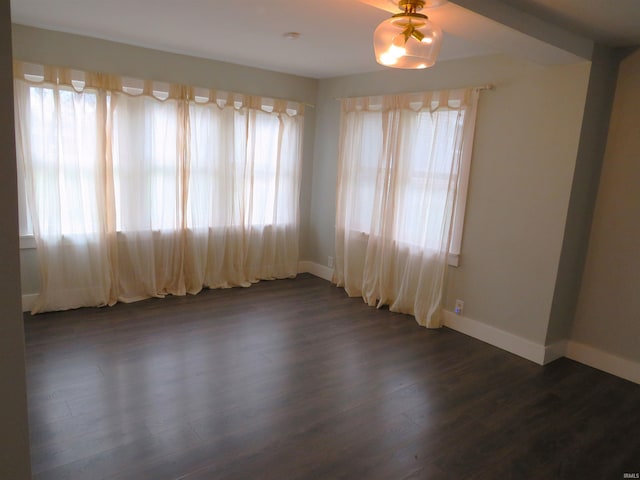 spare room with dark wood-type flooring