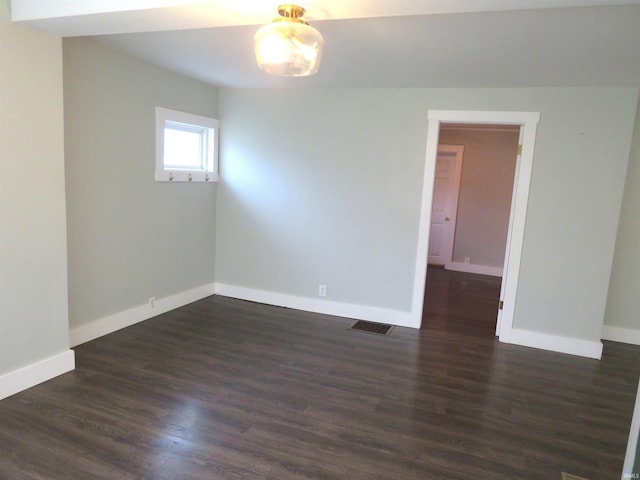 spare room with dark hardwood / wood-style flooring