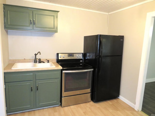 kitchen featuring black refrigerator, light wood-type flooring, stainless steel range with electric stovetop, ornamental molding, and sink