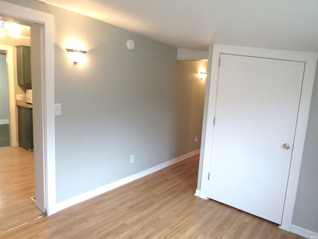 unfurnished bedroom with a closet and light hardwood / wood-style flooring