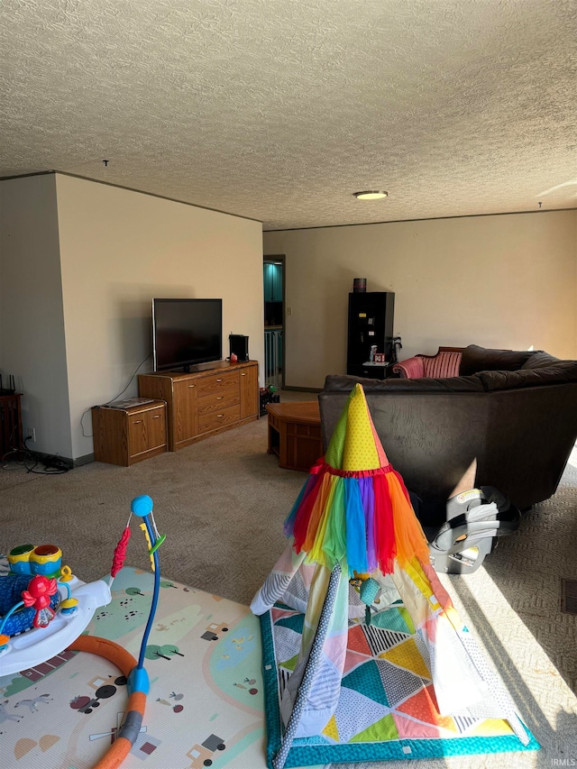 recreation room featuring carpet and a textured ceiling