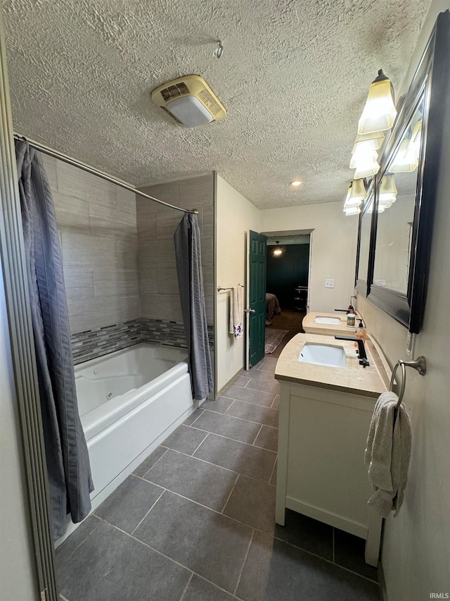 bathroom with tile patterned flooring, shower / bath combination with curtain, a textured ceiling, and vanity