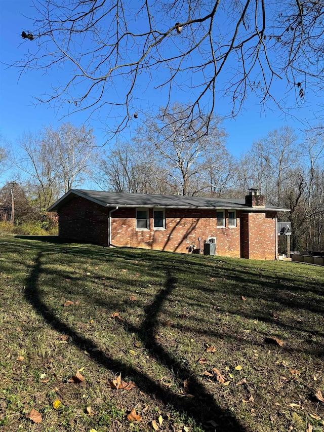 rear view of house with a yard