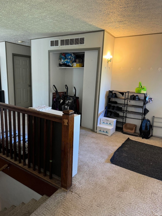 carpeted bedroom with a textured ceiling