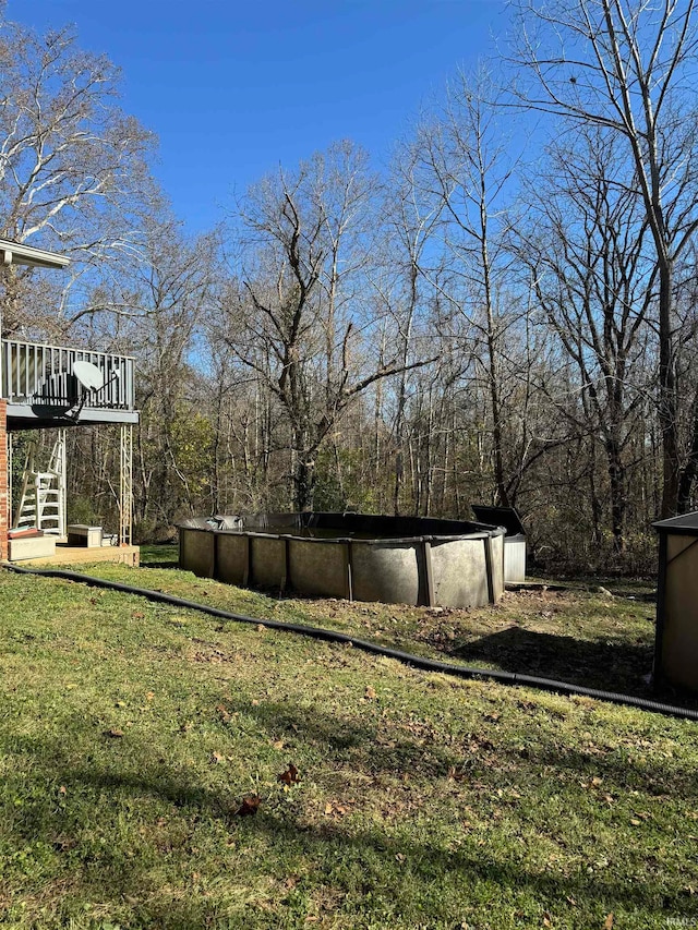 view of yard with a swimming pool side deck