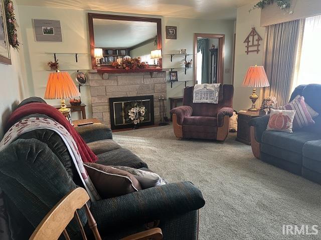 carpeted living room with a fireplace