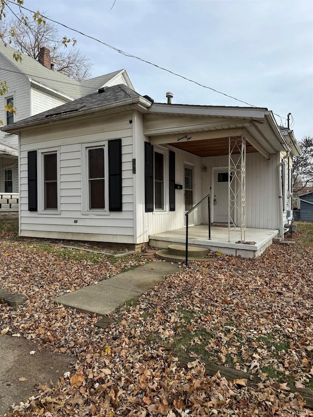 rear view of property featuring a porch