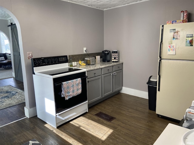 kitchen with gray cabinets, dark hardwood / wood-style flooring, and white appliances