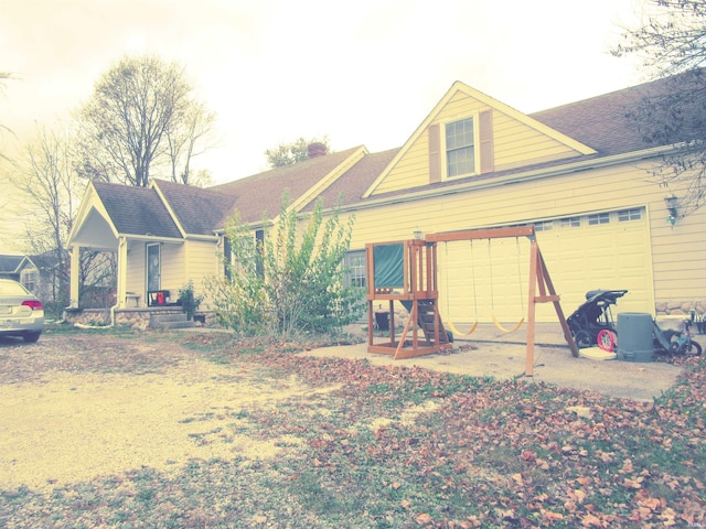 rear view of house featuring a garage