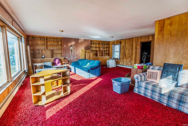 living room featuring wooden walls, carpet, and a baseboard heating unit